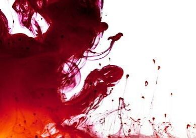 Red and orange ink swirling in water